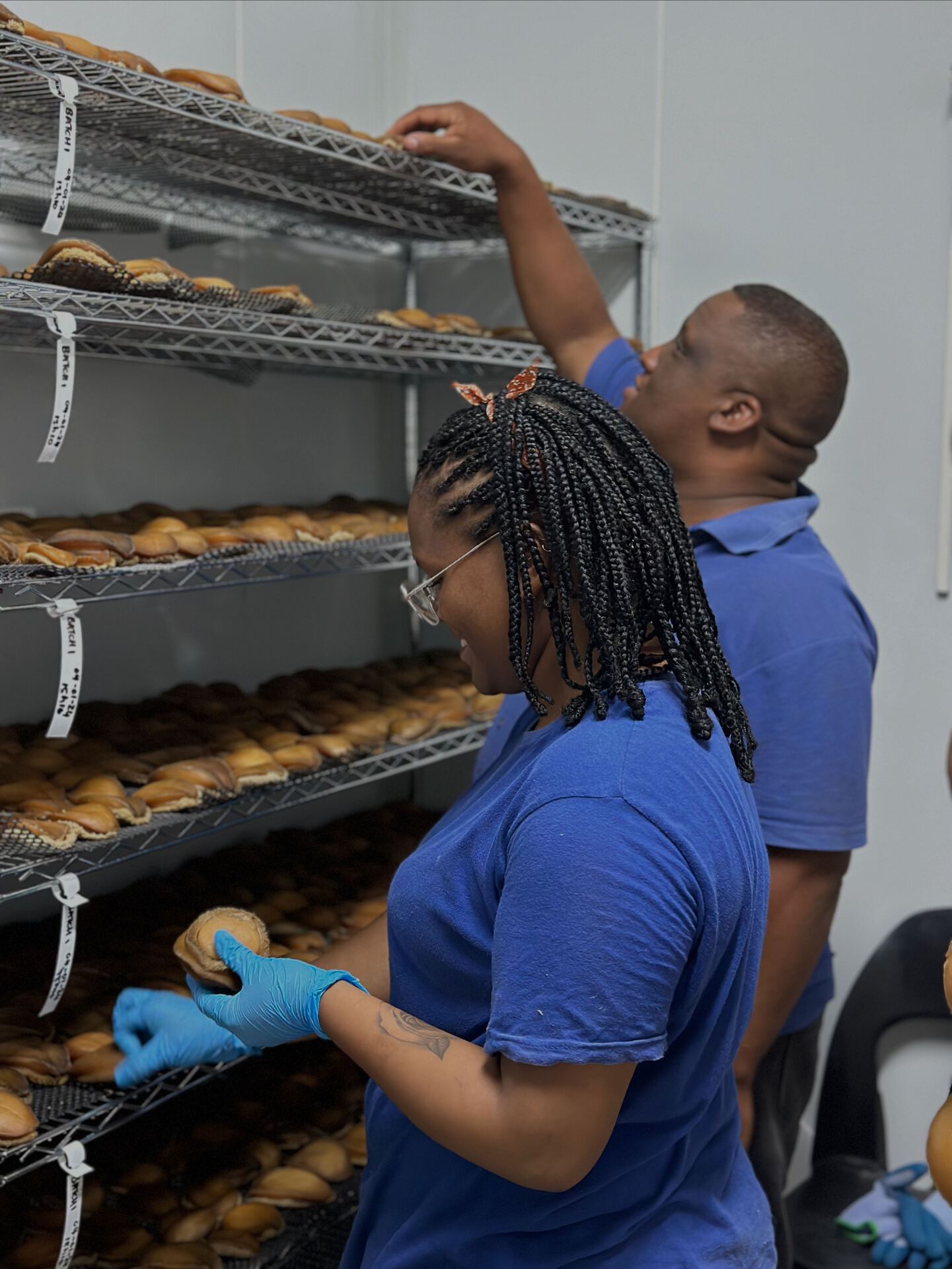 Production team inspecting drying racks of abalone